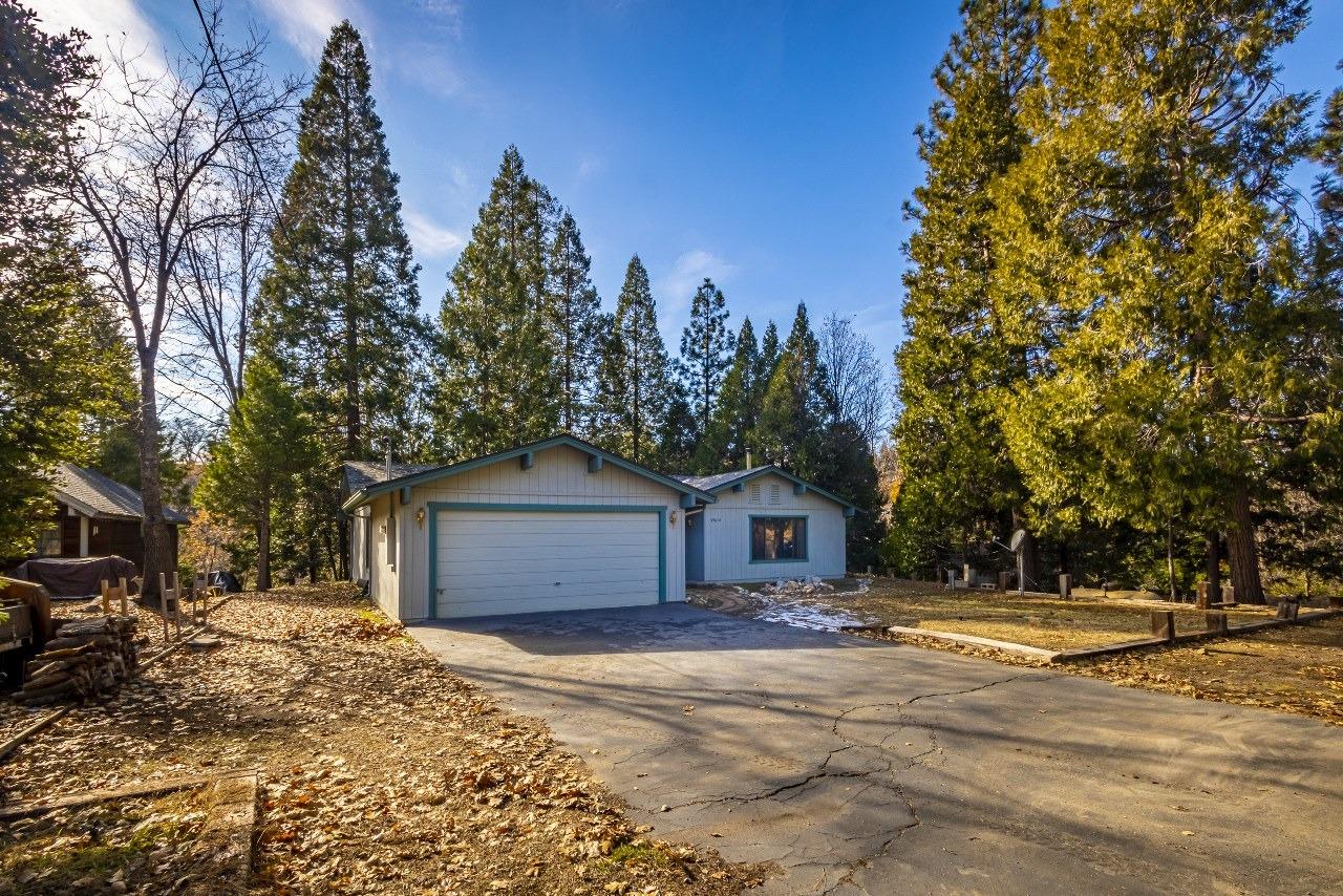 59634 Cascadel Drive North Fork, CA 93643 - Photo 38 of 52 a front view of a house with a yard and trees