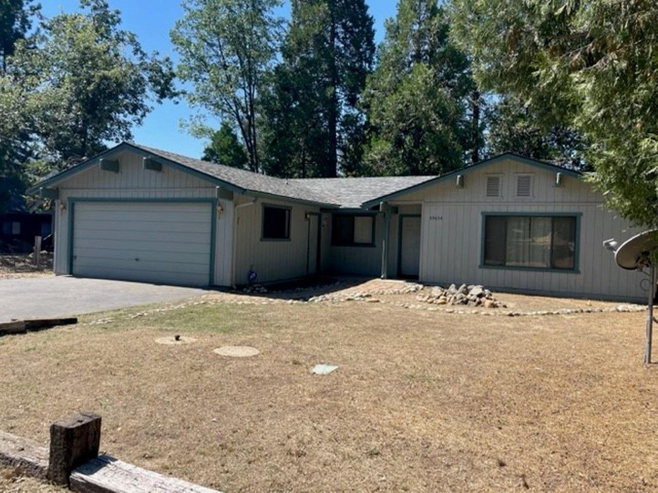 59634 Cascadel Drive North Fork, CA 93643 - Photo 45 of 52 a front view of a house with a yard