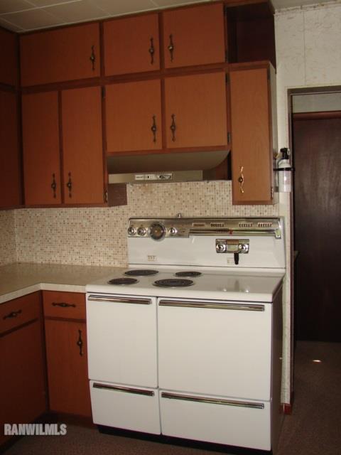 671 North Kent Road Kent, IL 61044 - Photo 6 of 22 a kitchen with granite countertop cabinets and white appliances
