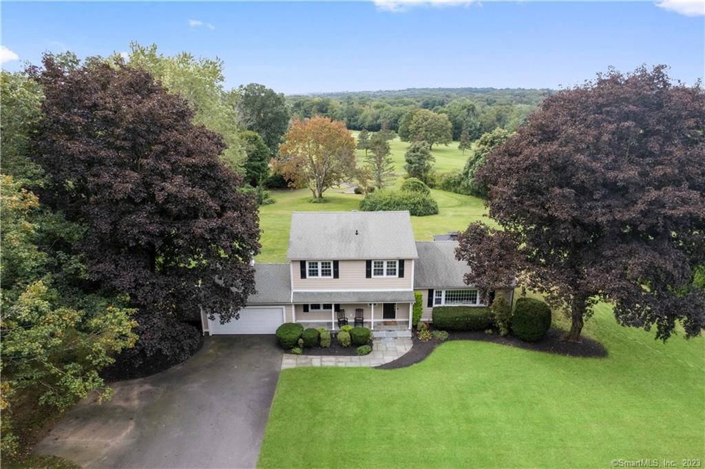 an aerial view of a house with swimming pool and garden