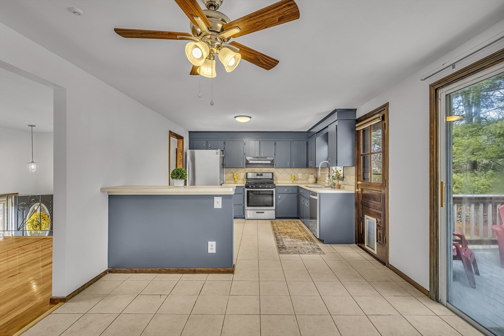 50 Harlow Road Rockland, MA 02370 - Photo 11 of 38 a kitchen with stainless steel appliances kitchen island granite countertop a refrigerator and a stove top oven