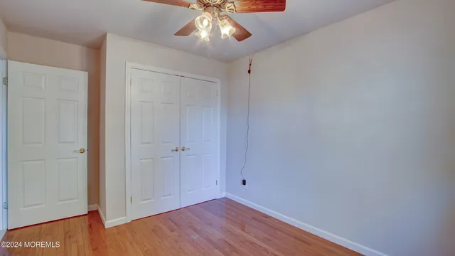 a view of a refrigerator in kitchen and empty room