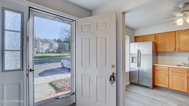 a view of a kitchen with wooden floor and doors