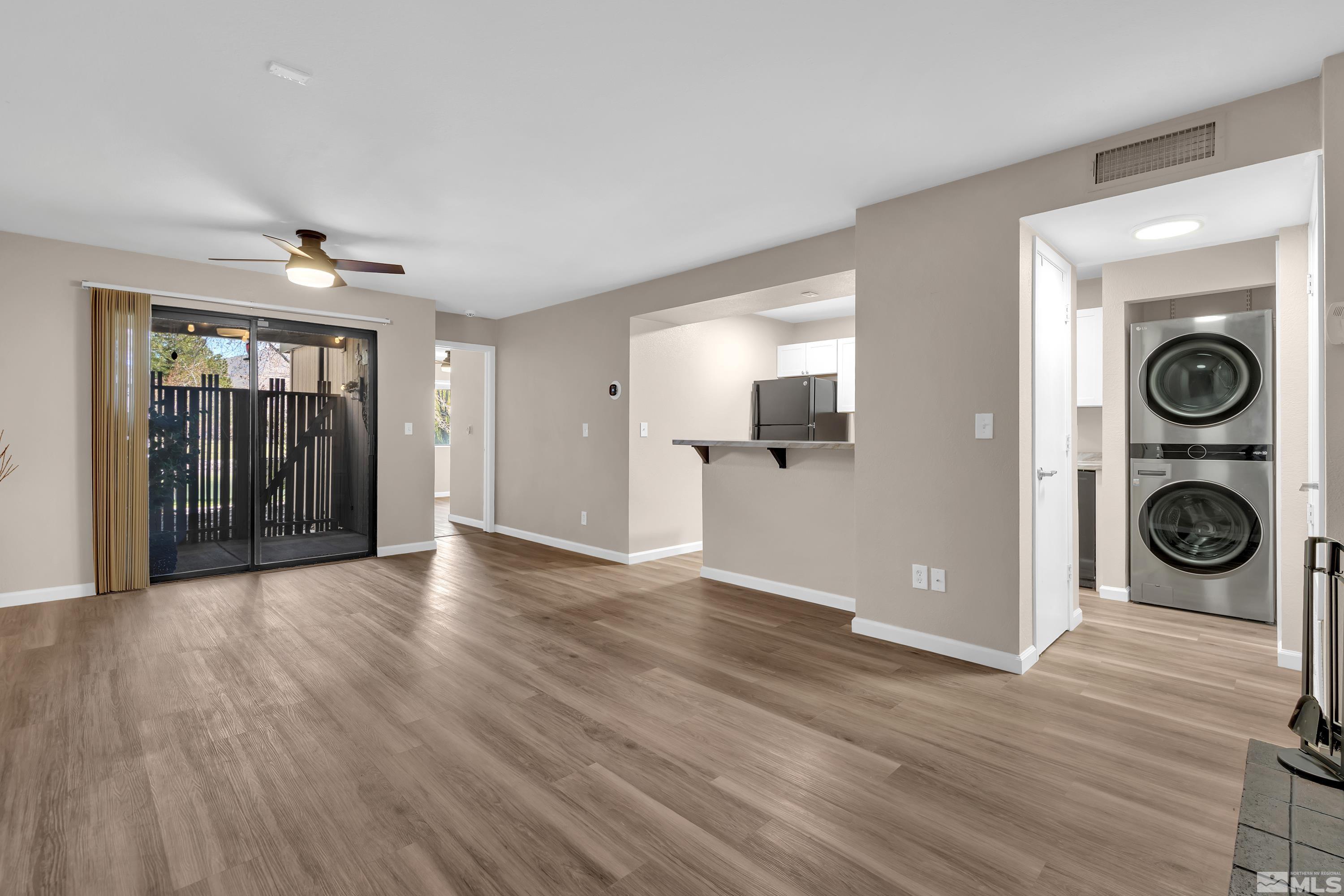 4468 Matich Drive Reno, NV 89502 - Photo 3 of 31 a view of an empty room with a window and wooden floor