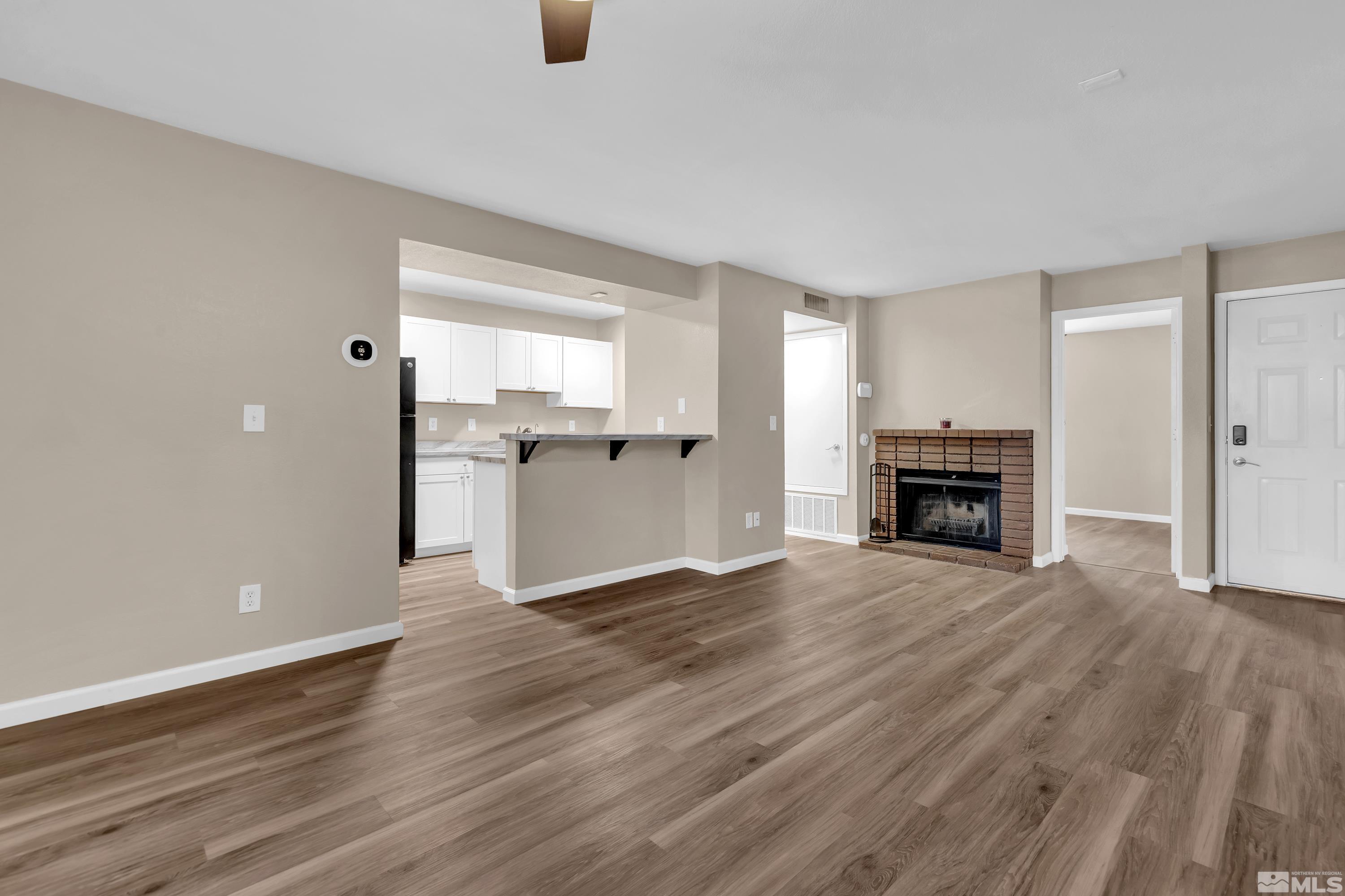 4468 Matich Drive Reno, NV 89502 - Photo 5 of 31 a view of empty room with wooden floor and window