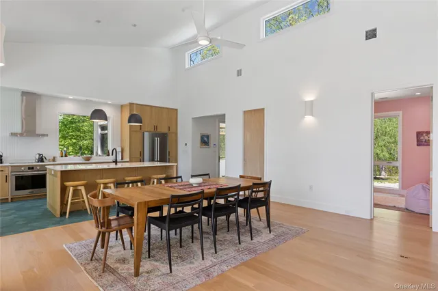 a view of a a dining room with furniture window and wooden floor