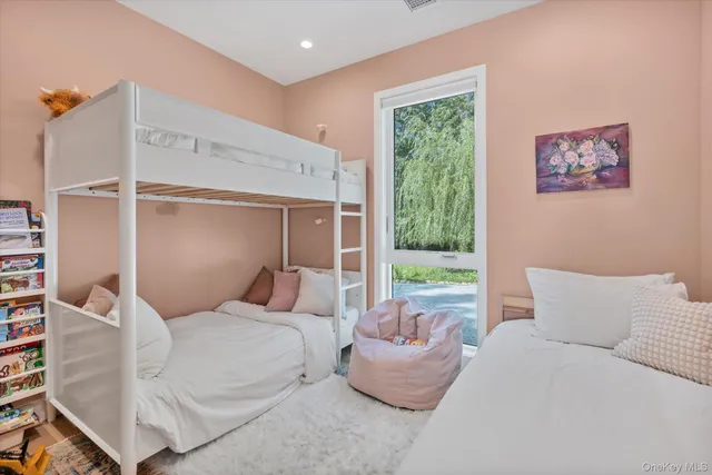 a bedroom with a large bed and a window