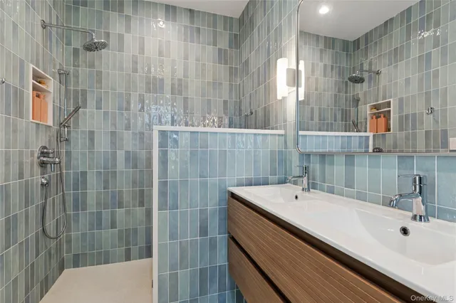 a bathroom with a double vanity sink and mirror