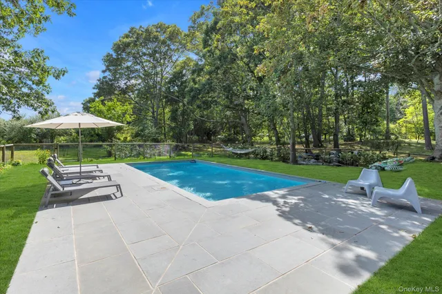 a view of backyard with outdoor seating and trees