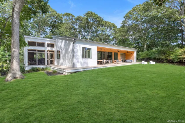 a front view of house with yard outdoor seating and green space
