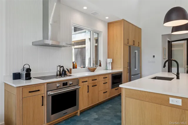 a kitchen with a sink stove and cabinets