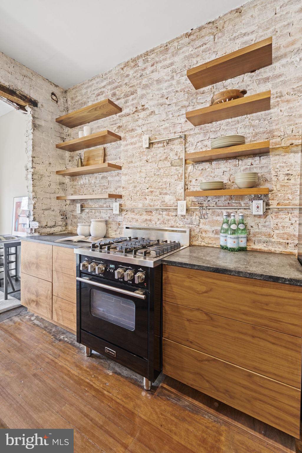 115 R Street Northwest Washington, DC 20001 - Photo 19 of 48 a kitchen with stainless steel appliances a stove and a refrigerator