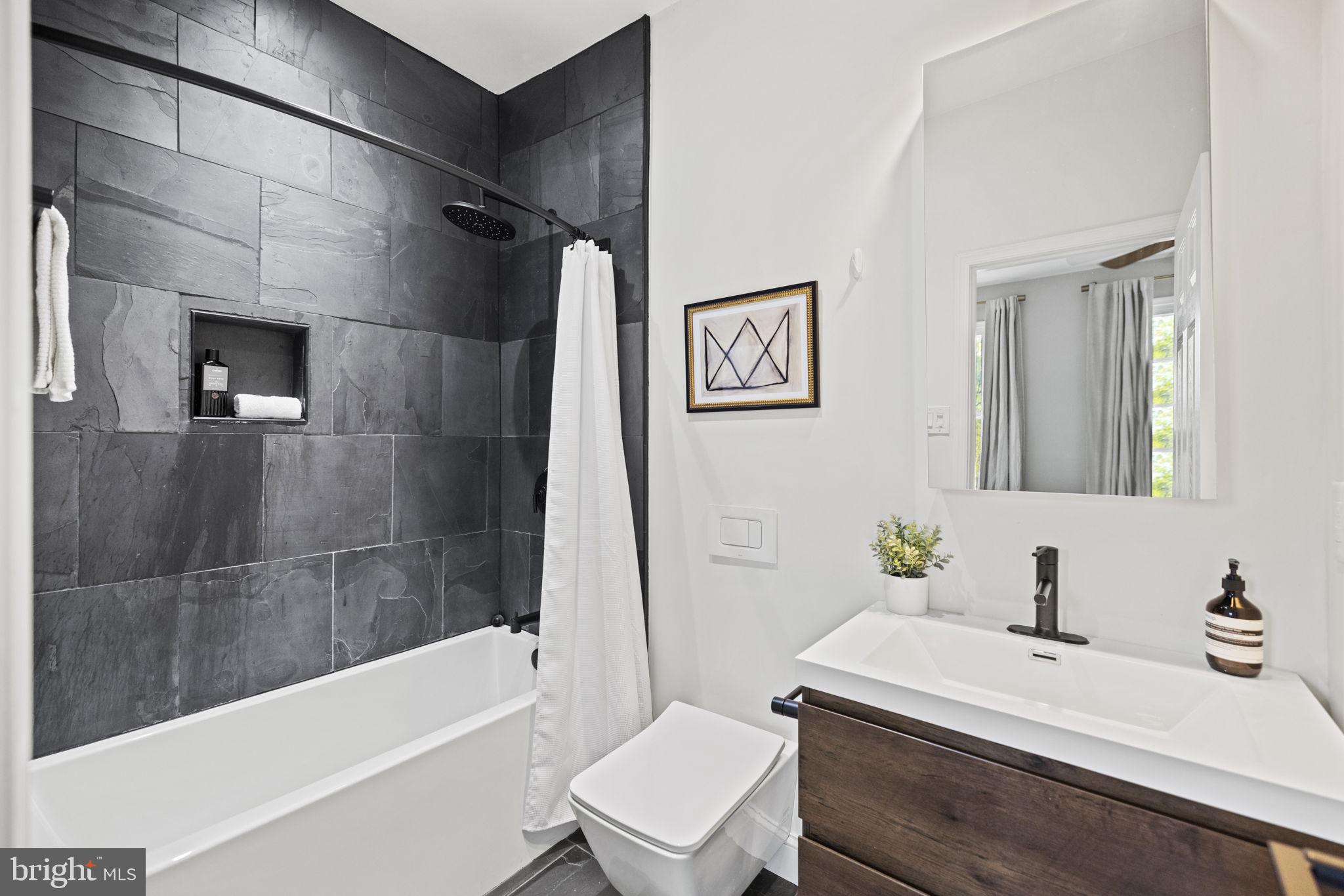 115 R Street Northwest Washington, DC 20001 - Photo 27 of 48 a bathroom with a sink a toilet and a bathtub