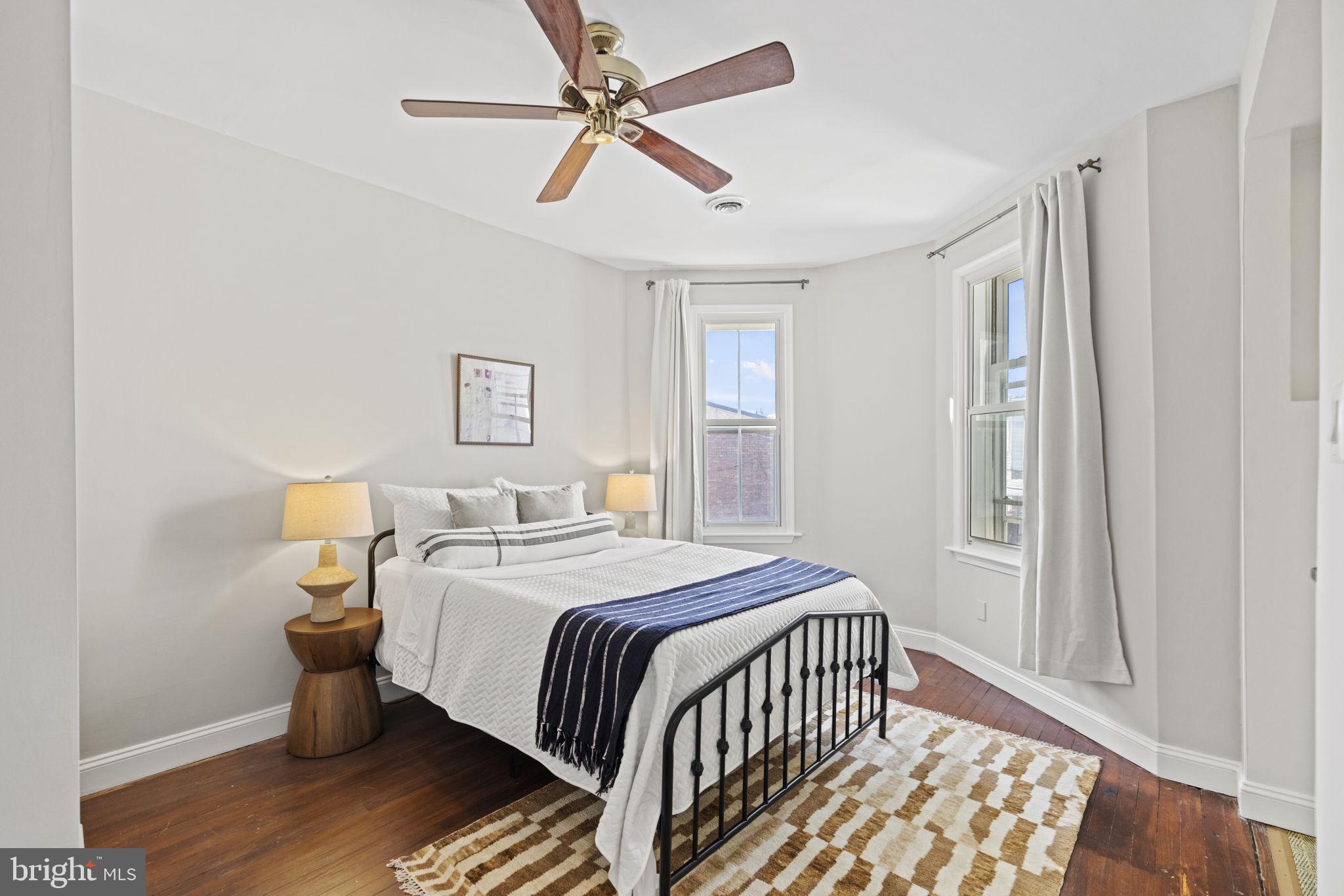 115 R Street Northwest Washington, DC 20001 - Photo 28 of 48 a bedroom with a bed and wooden floor