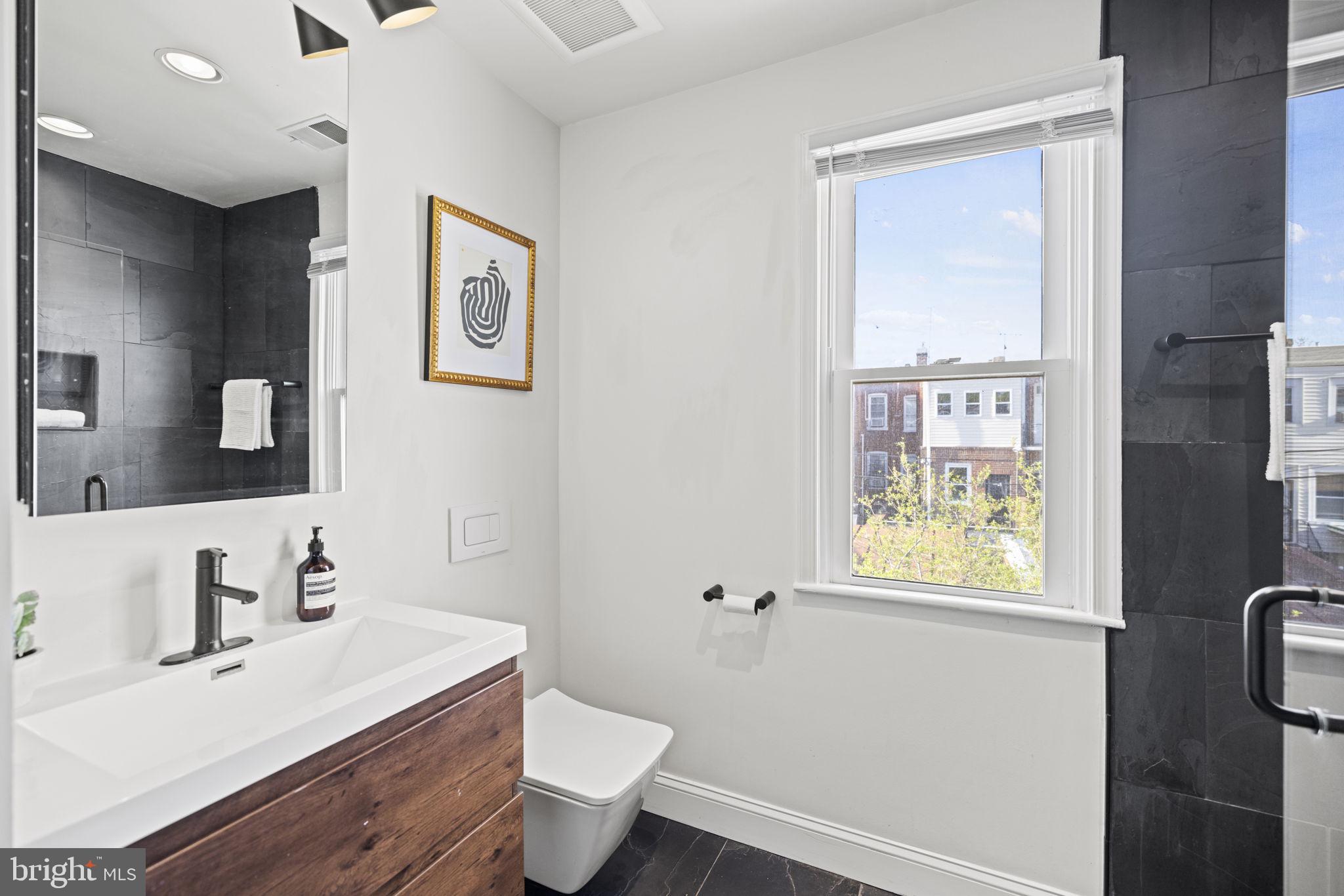 115 R Street Northwest Washington, DC 20001 - Photo 31 of 48 a bathroom with a toilet sink and mirror