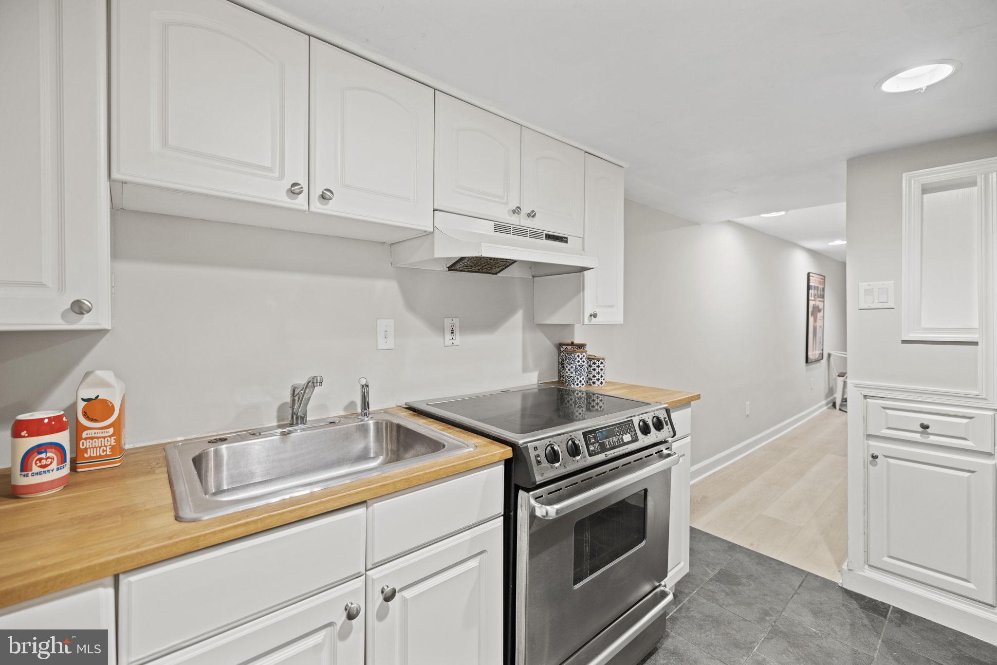 115 R Street Northwest Washington, DC 20001 - Photo 37 of 48 a kitchen with stainless steel appliances granite countertop white cabinets and a stove a oven with white countertops