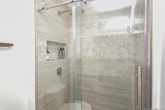 a bathroom with a glass shower door
