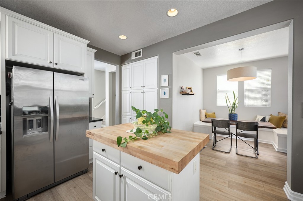 41 Ethereal Ladera Ranch, CA 92694 - Photo 12 of 35 a kitchen with stainless steel appliances a refrigerator and wooden floor