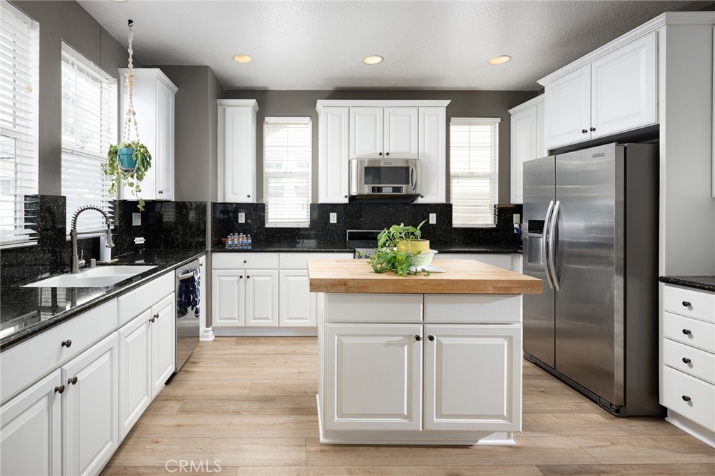 41 Ethereal Ladera Ranch, CA 92694 - Photo 13 of 35 a kitchen with white cabinets and refrigerator
