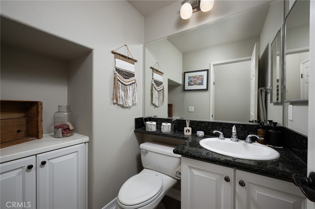 41 Ethereal Ladera Ranch, CA 92694 - Photo 15 of 35 a bathroom with a granite countertop sink a toilet and a mirror