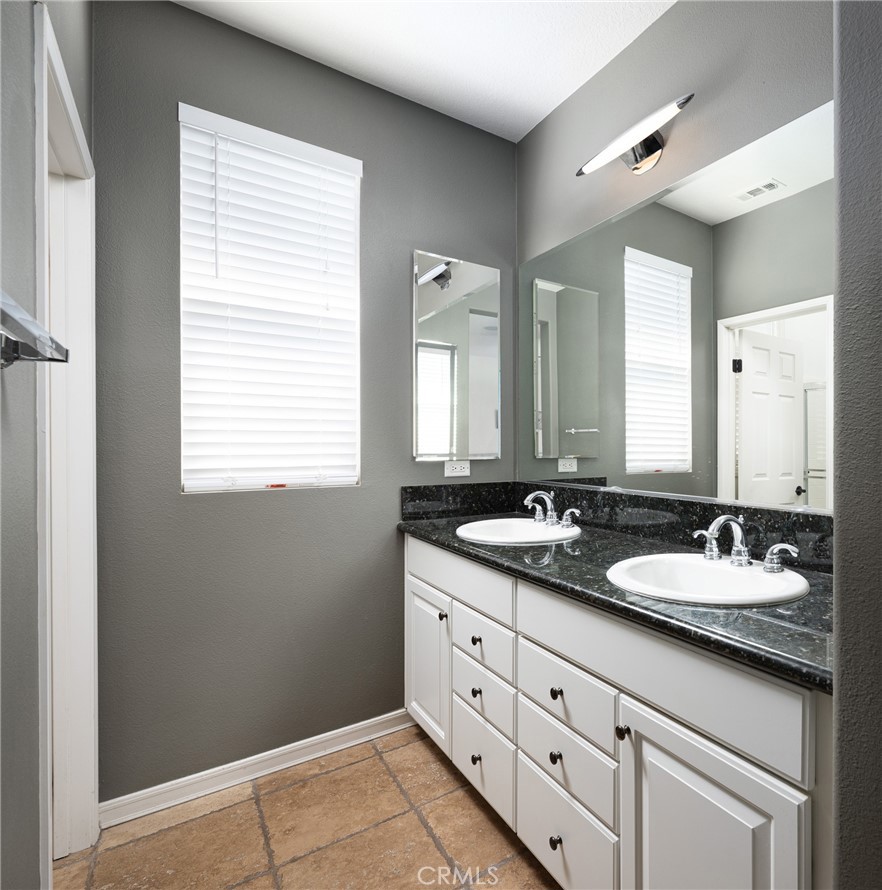 41 Ethereal Ladera Ranch, CA 92694 - Photo 19 of 35 a bathroom with double sink large mirror a vanity and a window
