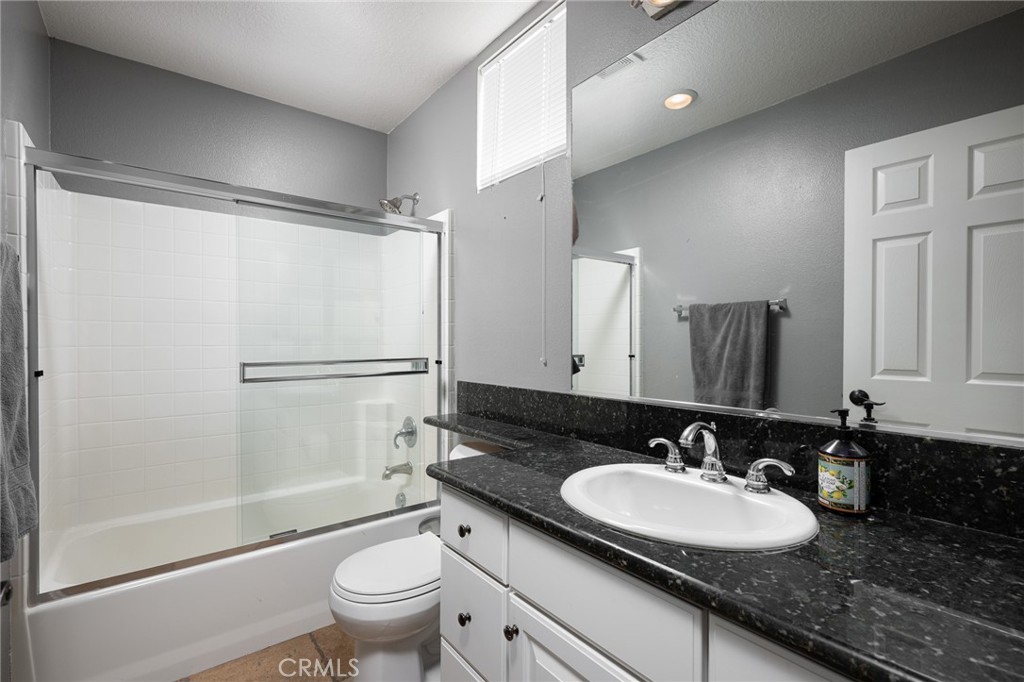 41 Ethereal Ladera Ranch, CA 92694 - Photo 4 of 35 a bathroom with a granite countertop sink toilet a mirror and shower