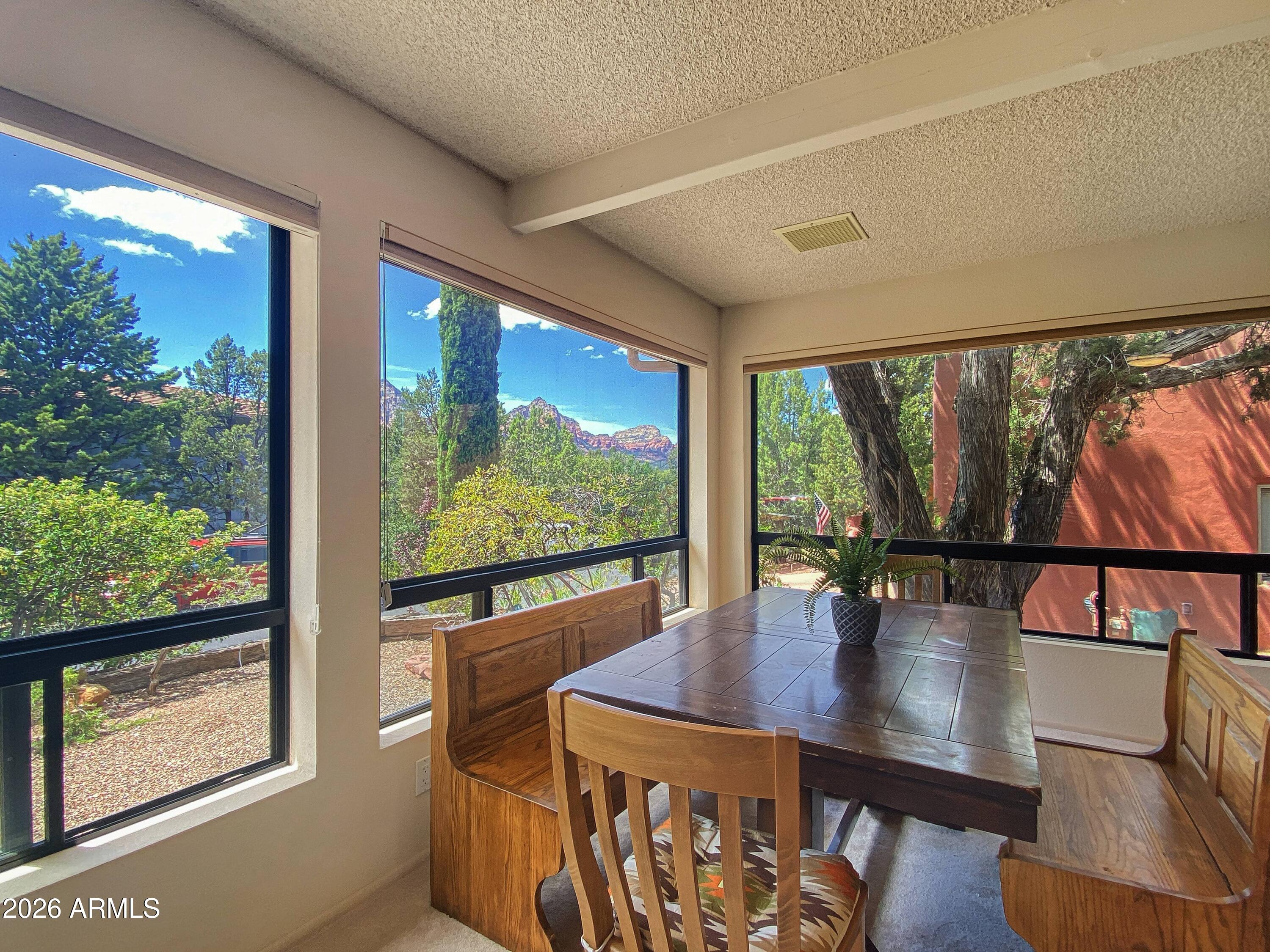 550 Barcelona Road Sedona, AZ 86336 - Photo 6 of 32 a view of a dining room with furniture window and wooden floor