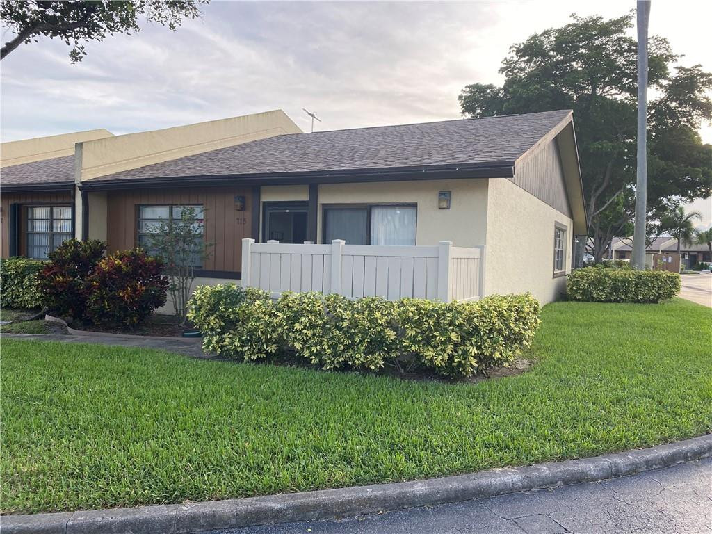 715 Banks Road, Unit 715 Margate, FL 33063 - Photo 19 of 23 a front view of a house with a garden