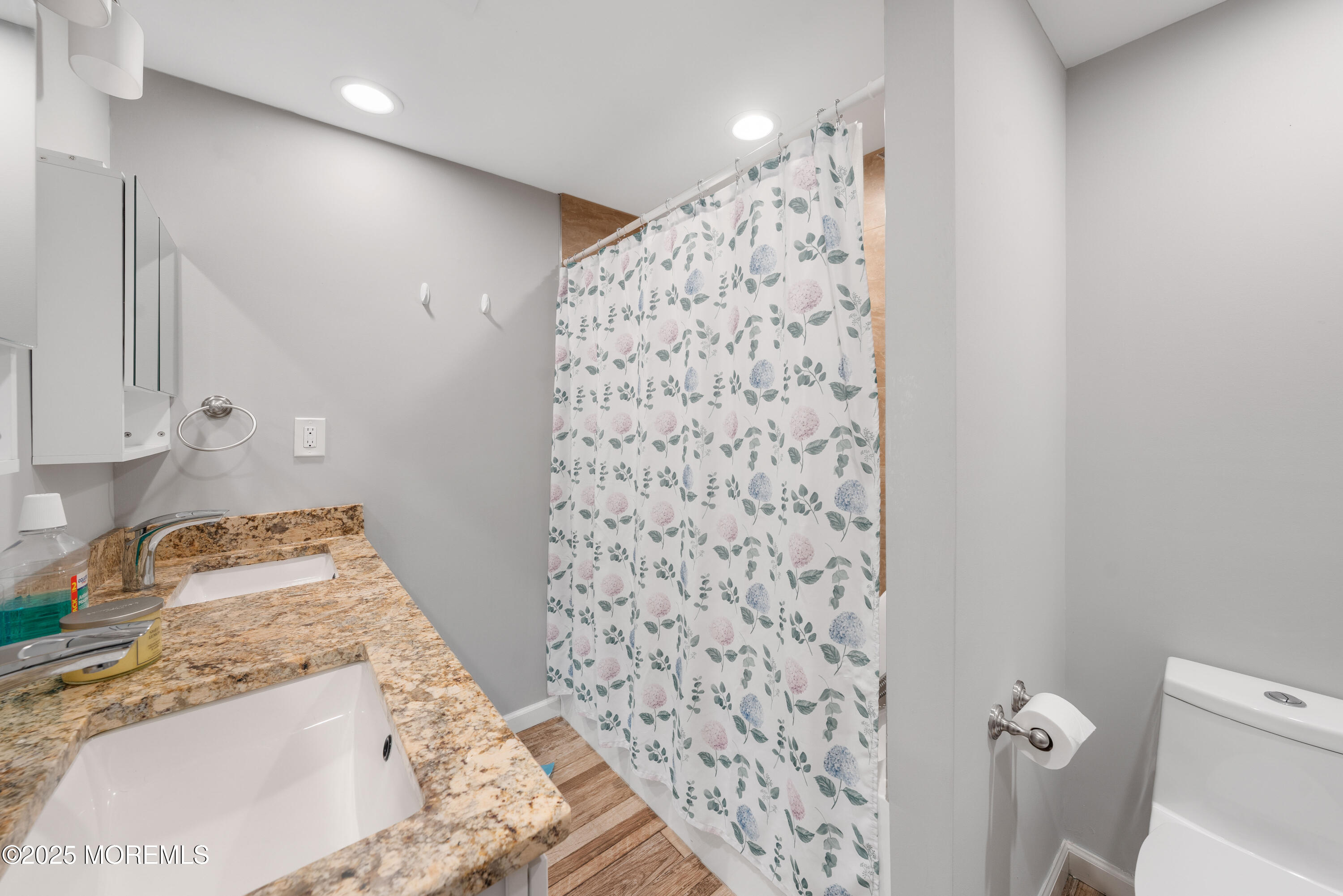 436 Applegate Avenue Toms River, NJ 08757 - Photo 19 of 27 a bathroom with a granite countertop sink a toilet and shower curtain