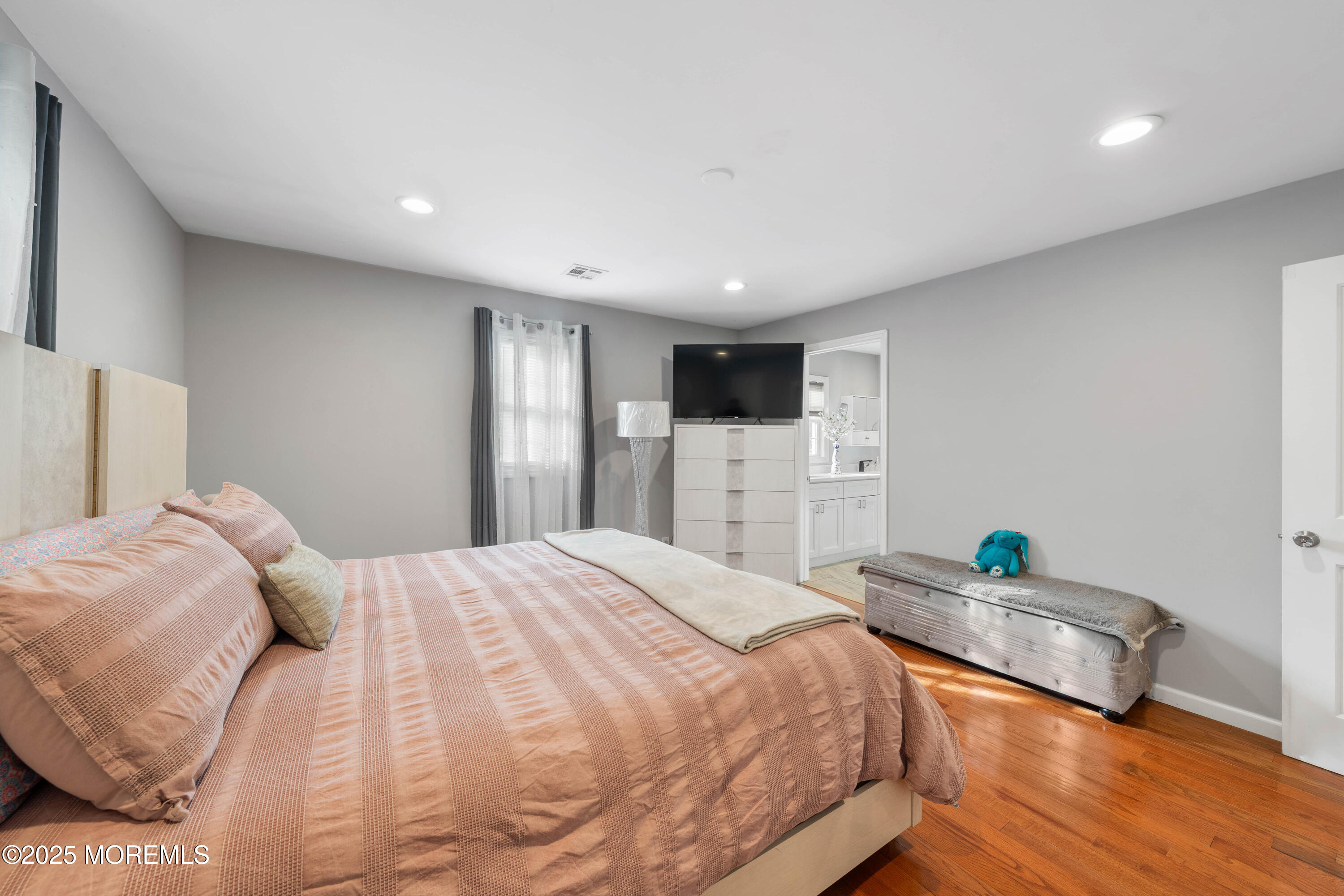 436 Applegate Avenue Toms River, NJ 08757 - Photo 8 of 27 a bedroom with a bed and a wooden floor