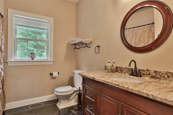 5 Snowcrest Run North Reading, MA 01864 - Photo 16 of 30 a bathroom with a granite countertop toilet a sink and a mirror