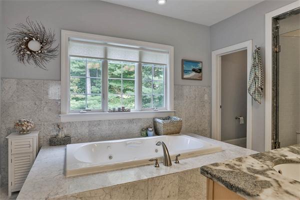 5 Snowcrest Run North Reading, MA 01864 - Photo 20 of 30 a bath tub sitting in a bathroom next to a window