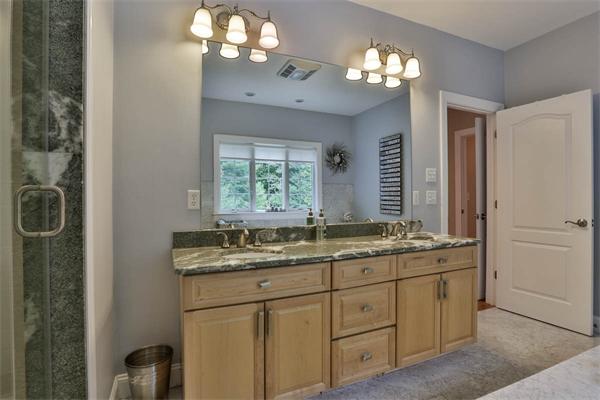 5 Snowcrest Run North Reading, MA 01864 - Photo 22 of 30 a bathroom with a granite countertop sink a light fixture and a mirror