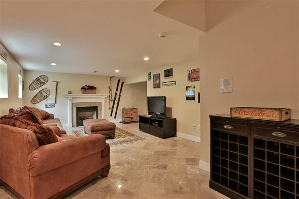 5 Snowcrest Run North Reading, MA 01864 - Photo 27 of 30 a living room with furniture a flat screen tv and a fireplace