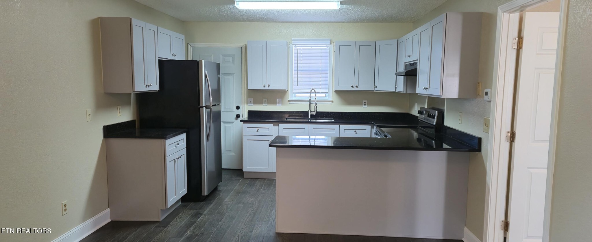 178 Fairview Road Crossville, TN 38571 - Photo 3 of 13 a kitchen with a refrigerator and a stove top oven