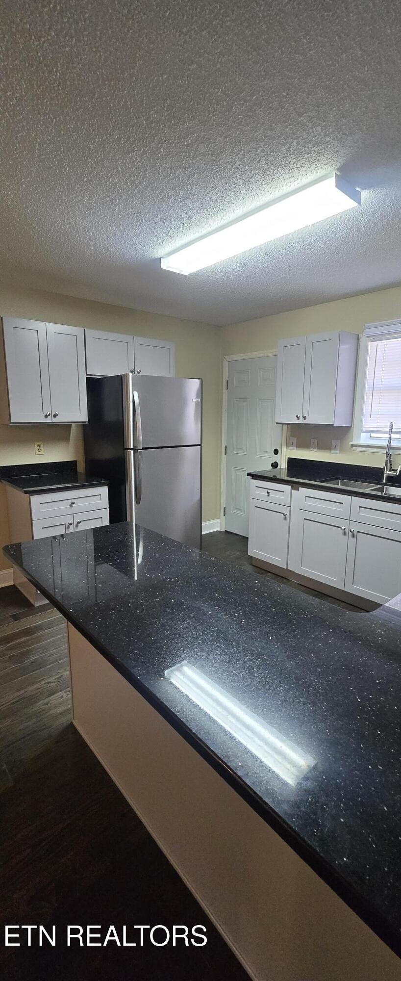 178 Fairview Road Crossville, TN 38571 - Photo 5 of 13 a kitchen with stainless steel appliances granite countertop a sink a stove and a refrigerator