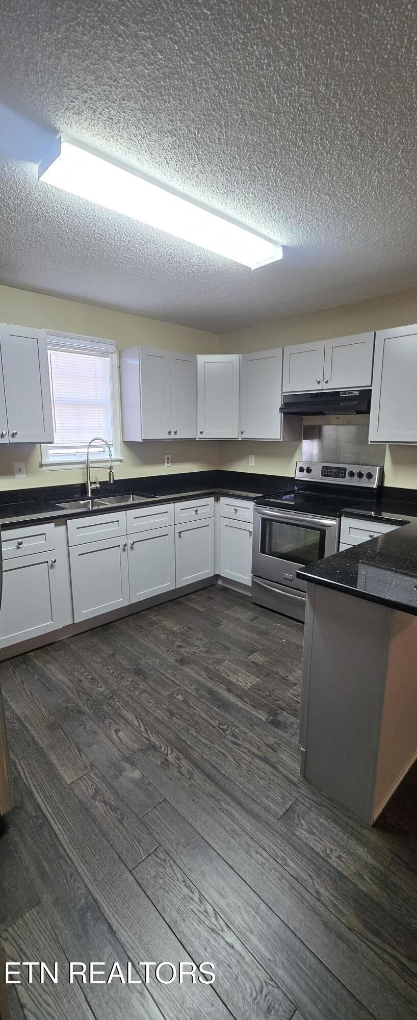 178 Fairview Road Crossville, TN 38571 - Photo 6 of 13 a kitchen with stainless steel appliances granite countertop a sink and a stove
