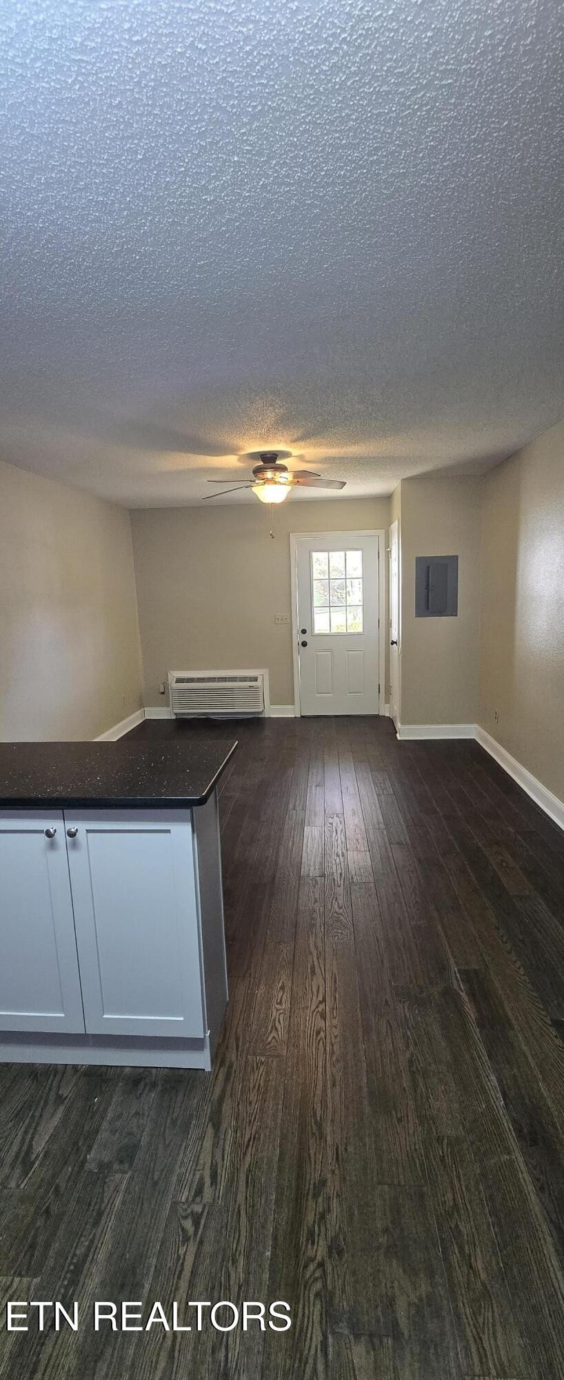 178 Fairview Road Crossville, TN 38571 - Photo 7 of 13 an empty room with wooden floor and windows