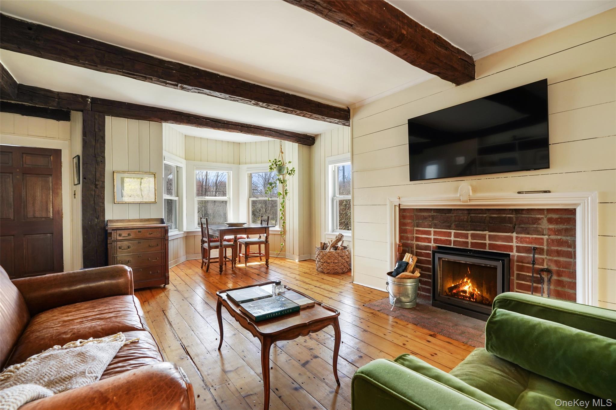 101 Hustis Road Cold Spring, NY 10516 - Photo 19 of 40 Absolutely charming living rm with hand hewn beams, fireplace and wide plank natural floors