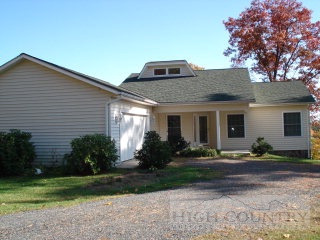 1964 Benge Ashe Road Purlear, NC 28665 - Photo 1 of 1 a front view of a house with garden and porch