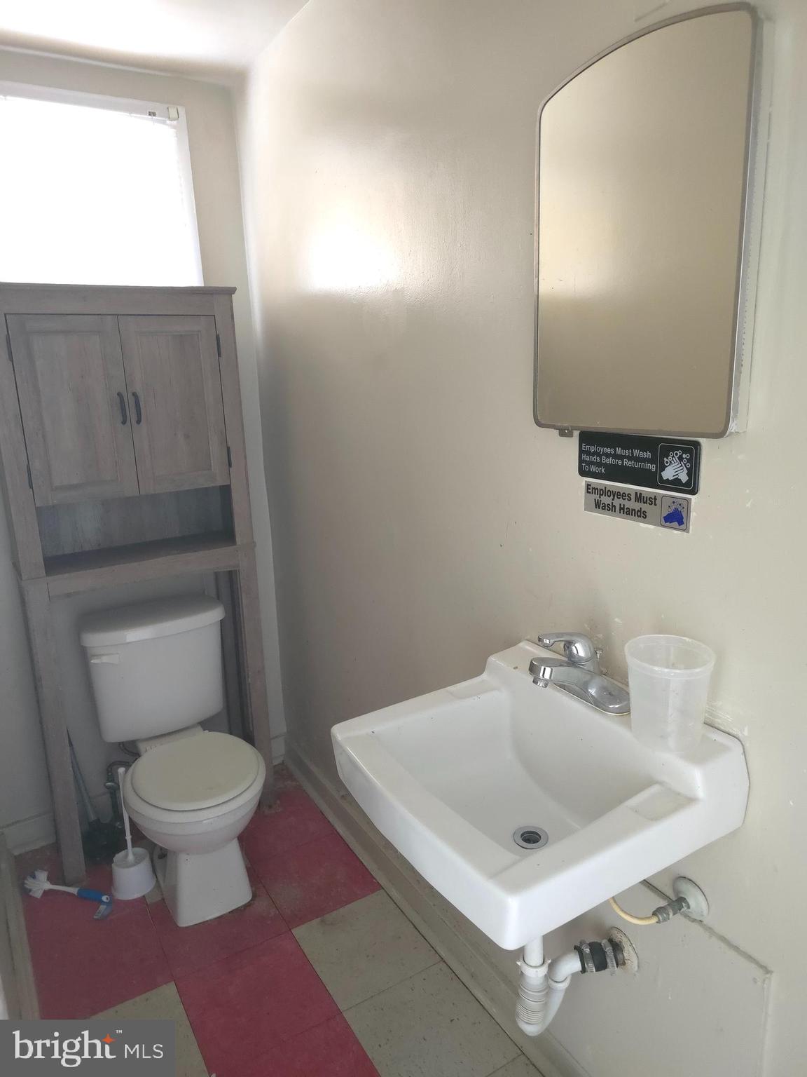 210 Long Lane Upper Darby, PA 19082 - Photo 10 of 21 a bathroom with a toilet sink and mirror