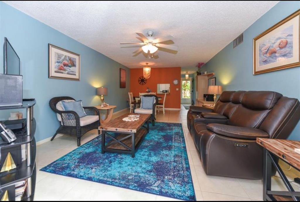 2615 Northeast 3rd Street, Unit 217 Boynton Beach, FL 33435 - Photo 12 of 55 a living room with furniture and a rug
