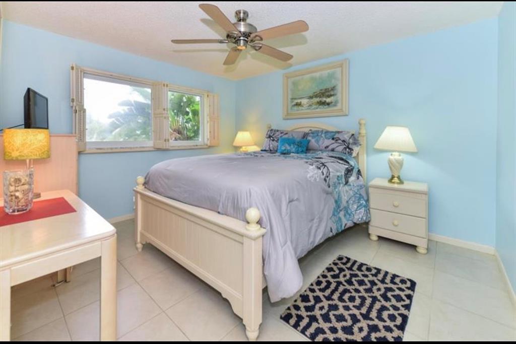 2615 Northeast 3rd Street, Unit 217 Boynton Beach, FL 33435 - Photo 18 of 55 a bedroom with a bed and a table with chair