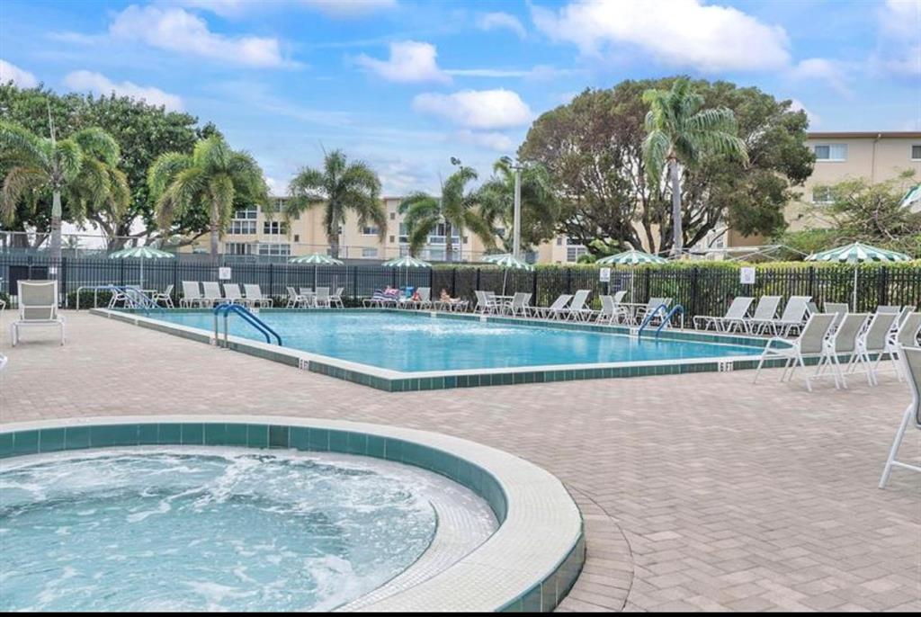 2615 Northeast 3rd Street, Unit 217 Boynton Beach, FL 33435 - Photo 27 of 55 a view of a swimming pool with a patio