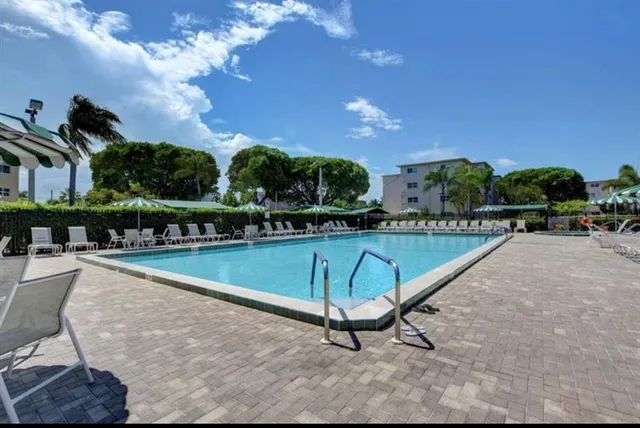 aerial view of a house with yard swimming pool and outdoor seating