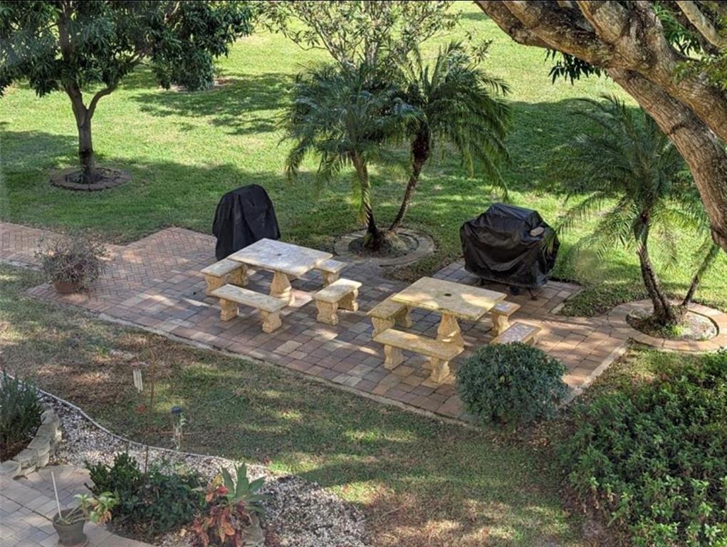 2615 Northeast 3rd Street, Unit 217 Boynton Beach, FL 33435 - Photo 35 of 55 a backyard of a house with table and chairs