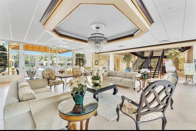 a living room with lots of furniture and a chandelier