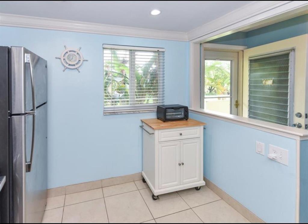 2615 Northeast 3rd Street, Unit 217 Boynton Beach, FL 33435 - Photo 5 of 55 a view of a kitchen with white cabinets and a window
