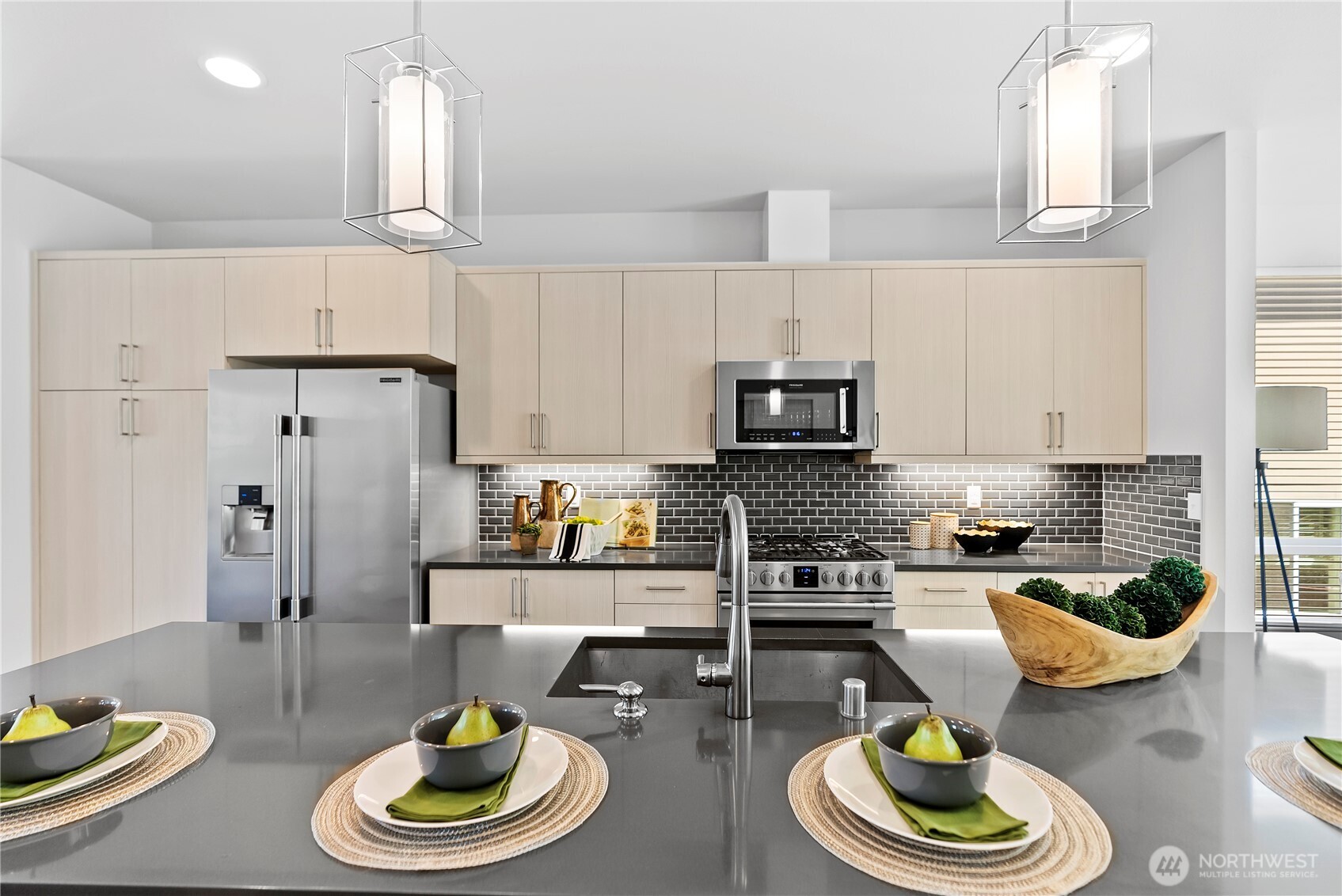 17905 35th Avenue Southeast, Unit A1 Bothell, WA 98012 - Photo 12 of 36 a kitchen with stainless steel appliances a dining table and chairs