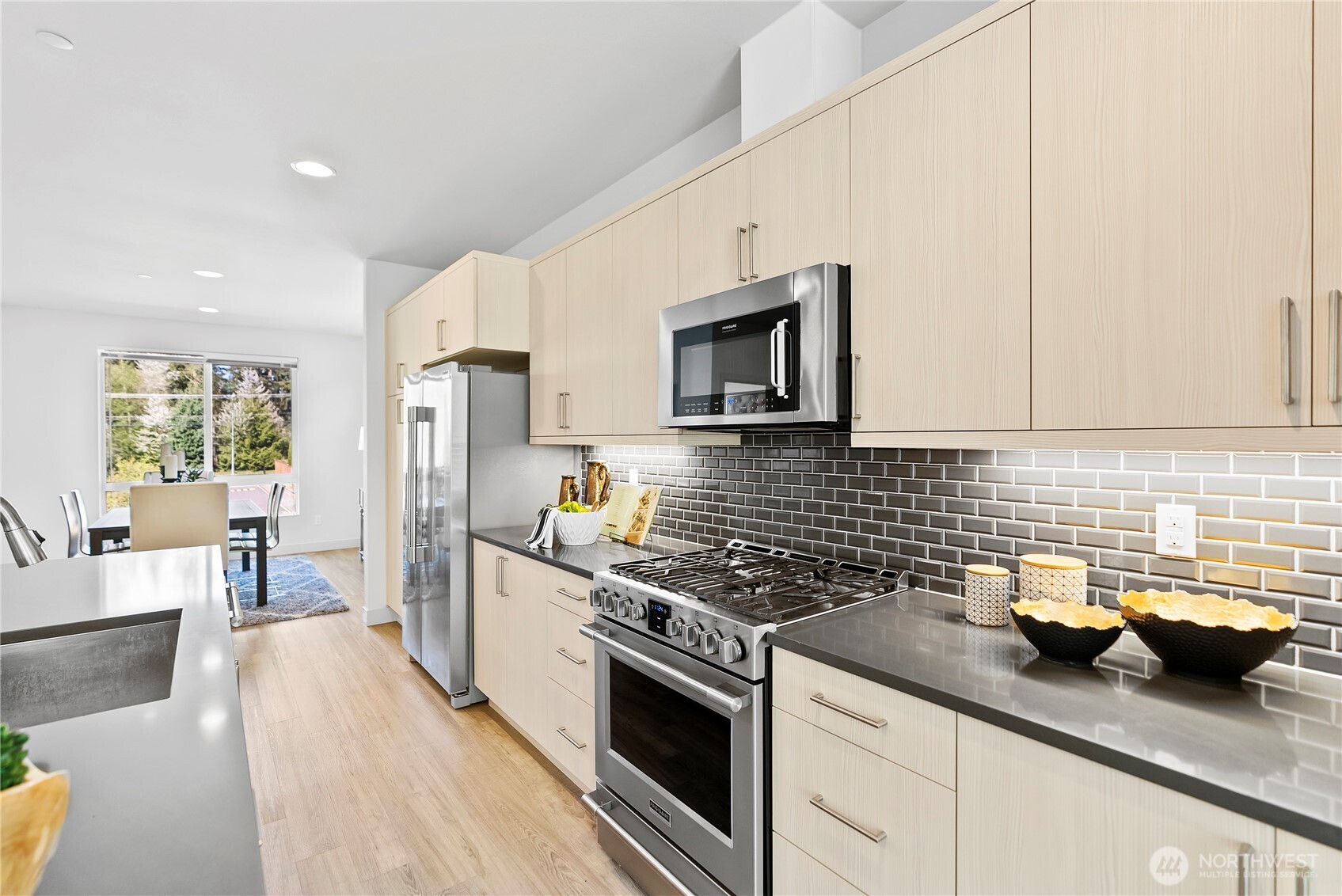 17905 35th Avenue Southeast, Unit A1 Bothell, WA 98012 - Photo 14 of 36 a kitchen with granite countertop a sink a stove and cabinets